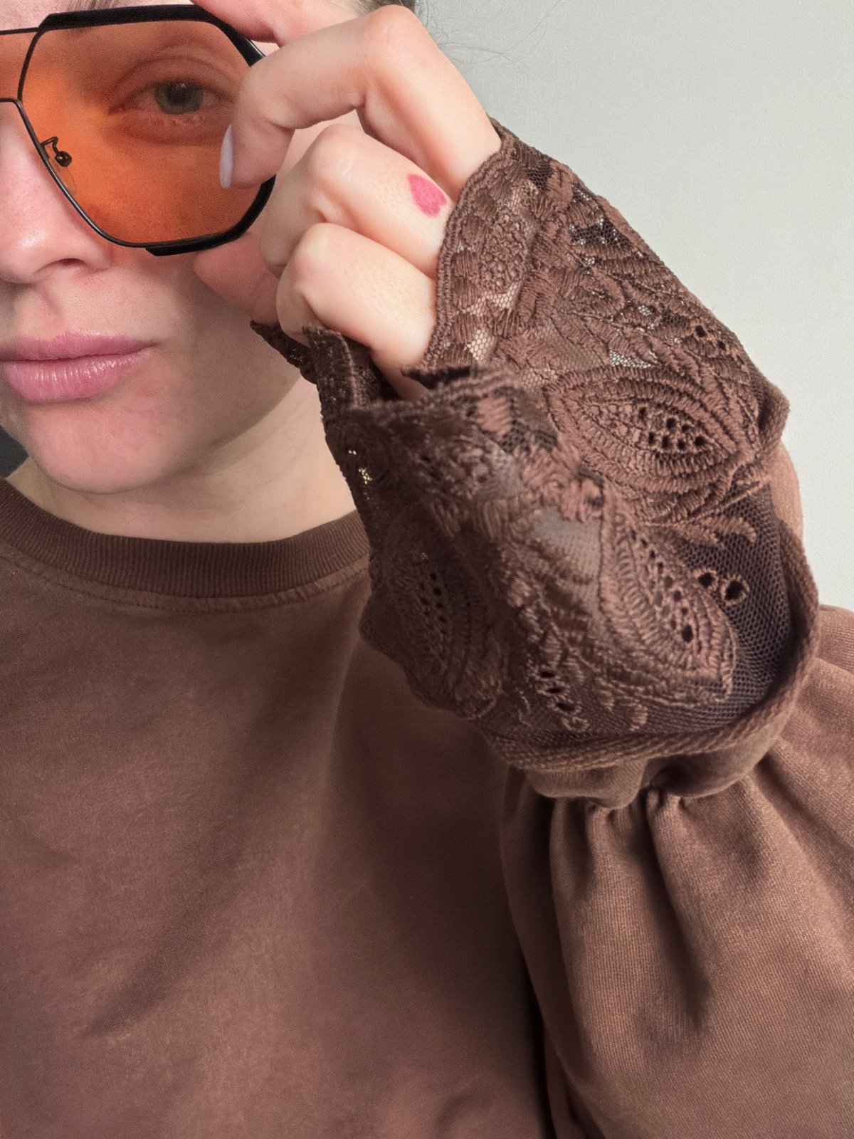 Woman poses with orange-tinted sunglasses in Moscow