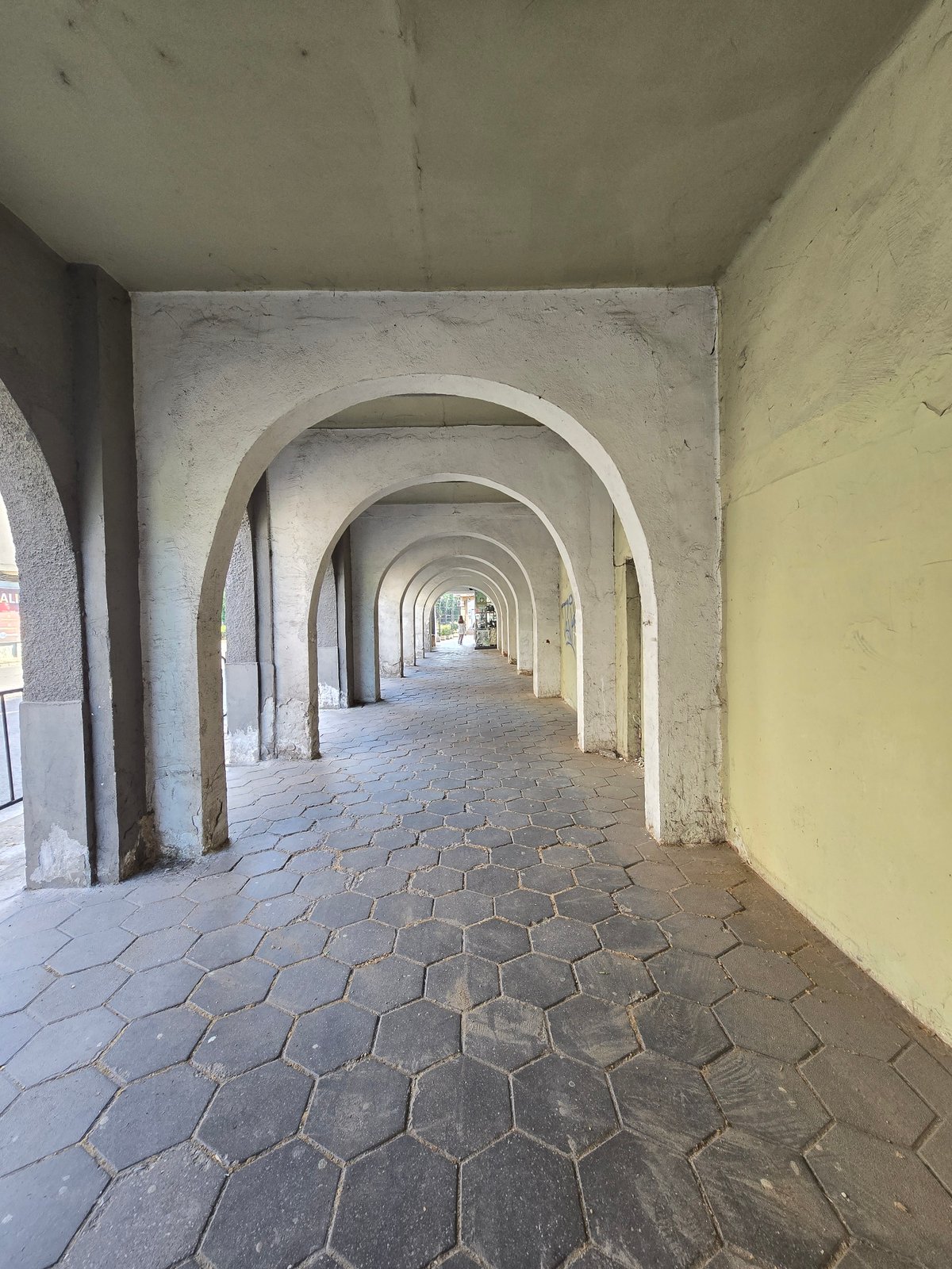Architectural walkway with arches documented in unidentified urban location