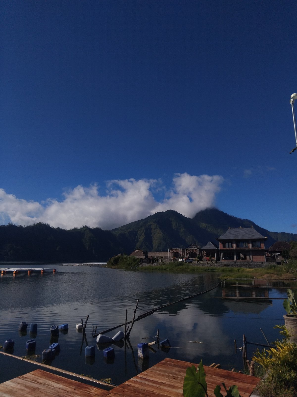 Witness documents lakeside mountain landscape with modern buildings