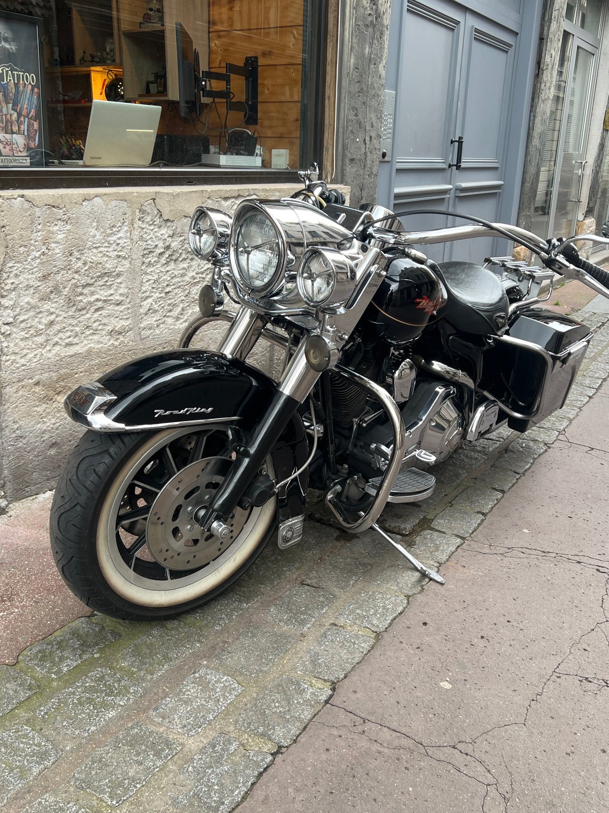 Historic Rouen buildings with teddy bears, parked motorcycle documented