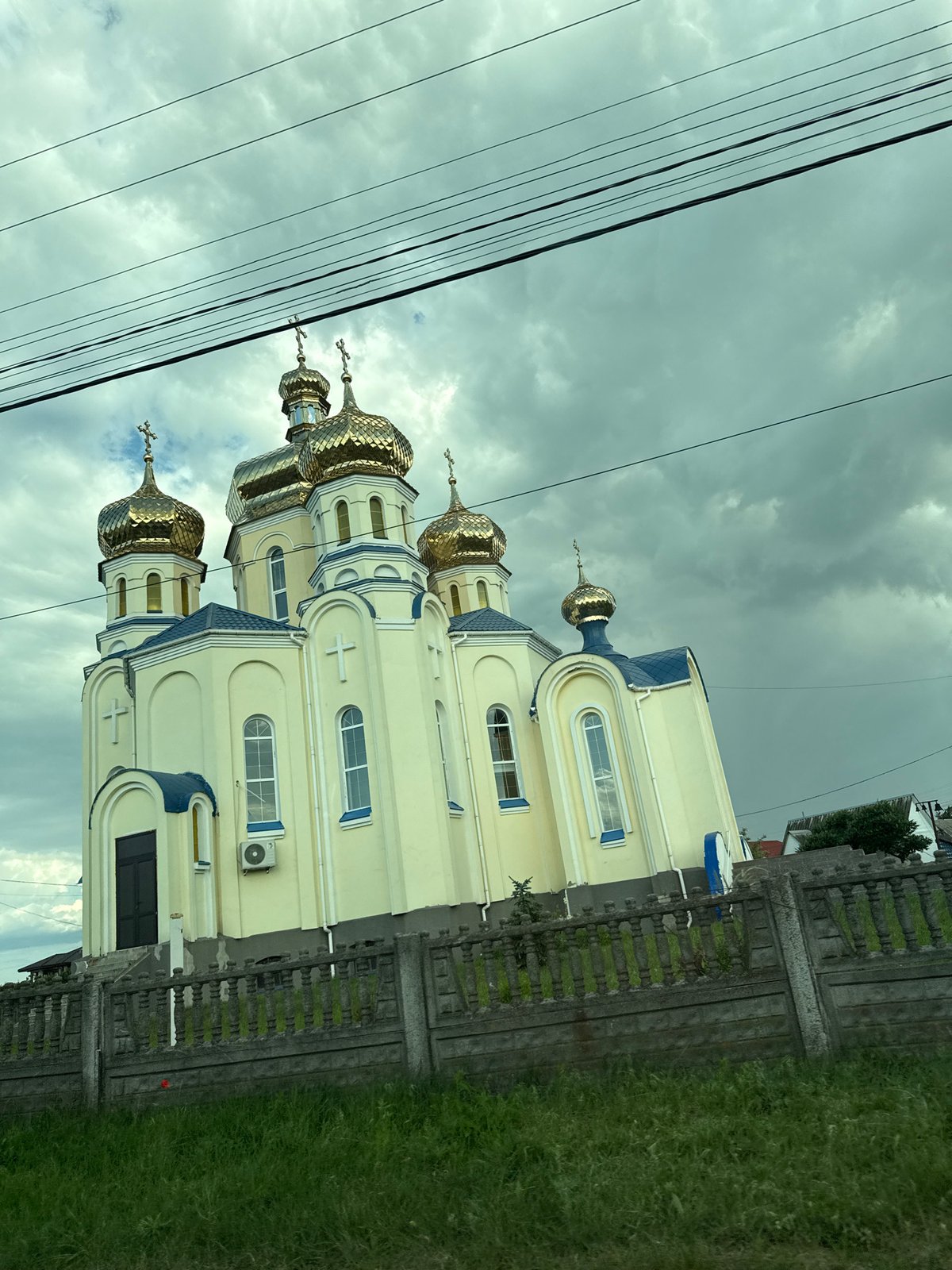 Golden-domed Orthodox church with blue trim in rural Ukraine