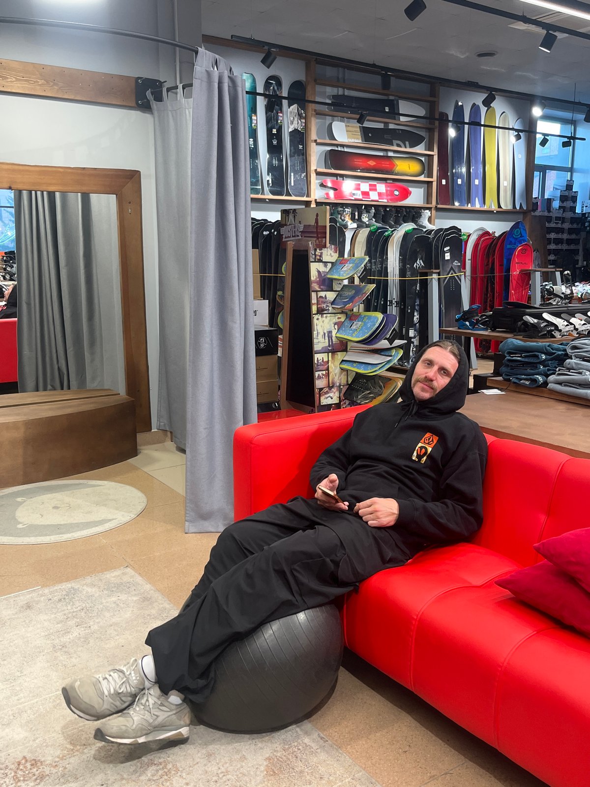 Man relaxes on sofa in Krasnoyarsk retail store