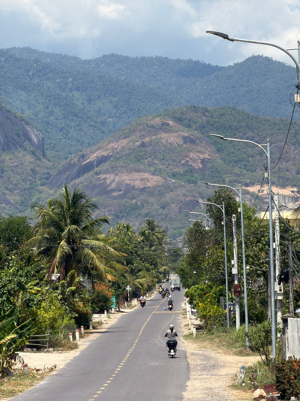 Morning traffic flows on mountain road in Diên Thọ, Vietnam