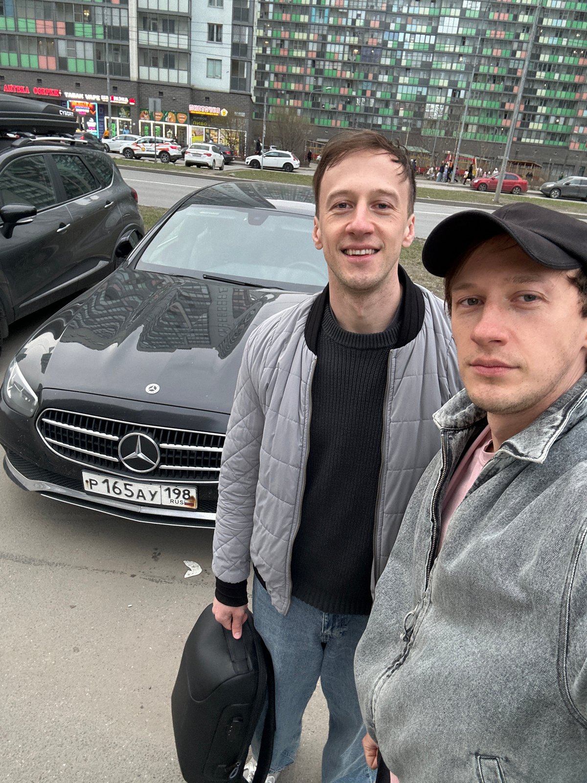 Two men photographed with Mercedes-Benz in Murino, Russia