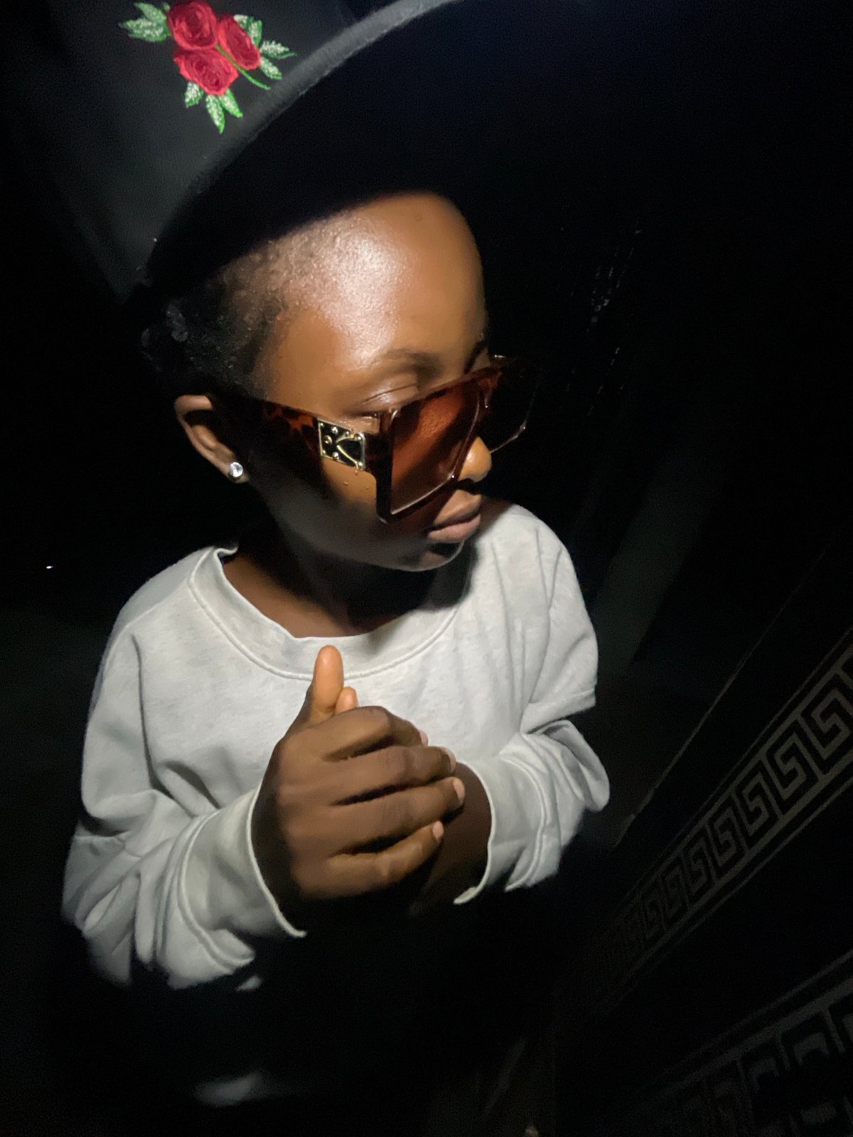 Young person poses for photos in Lokoja wearing sunglasses