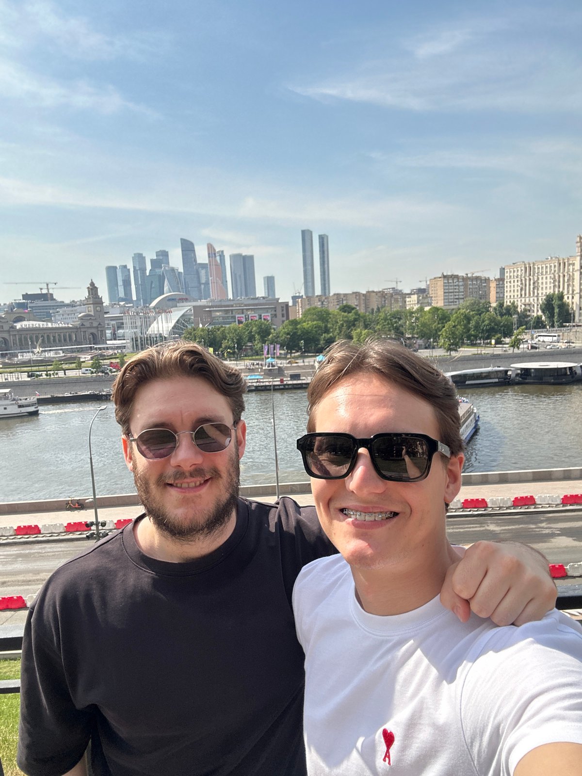 Two men photograph selfie at Moscow River embankment