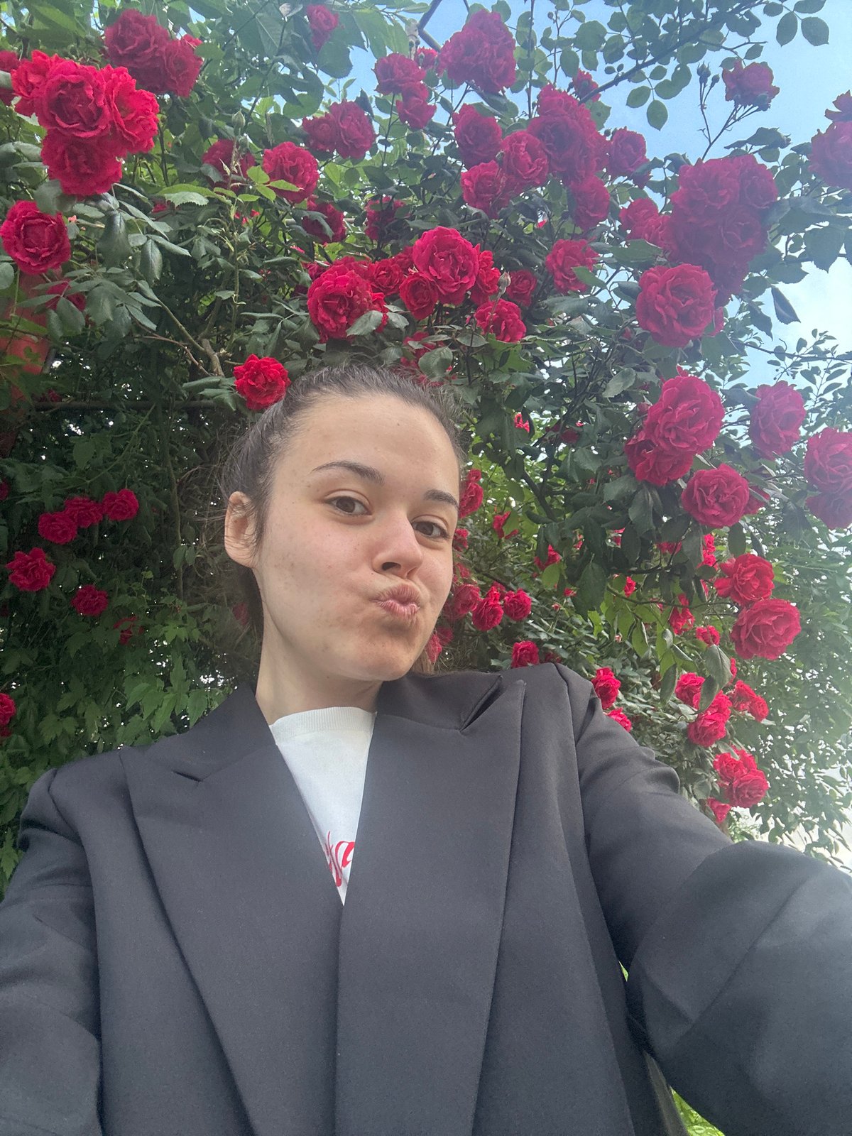 Couple photographs themselves among blooming roses in Sofia