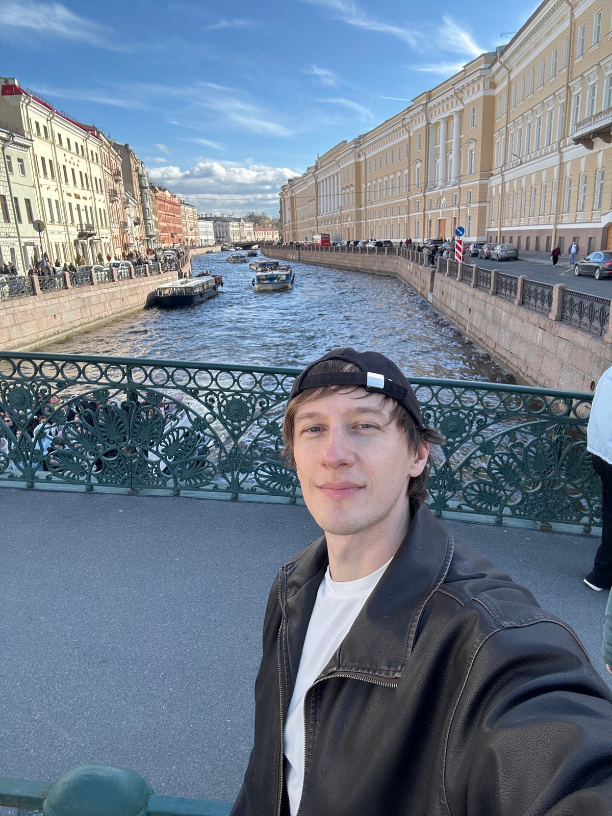 Tourists gather at Saint Petersburg canals during sunny afternoon