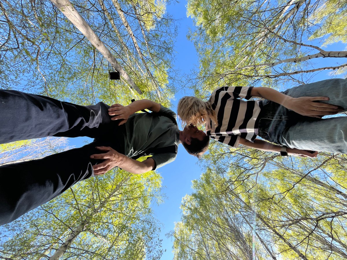 Young family enjoys spring morning in Russian birch forest