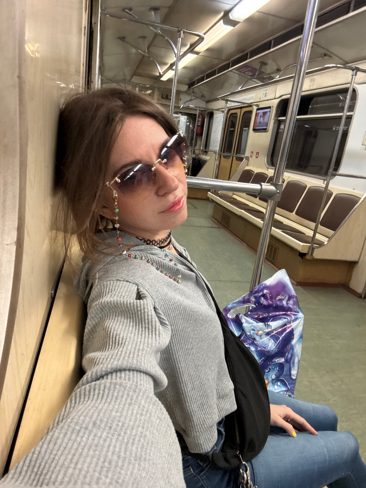 Woman rests on Moscow Metro train during early morning hours