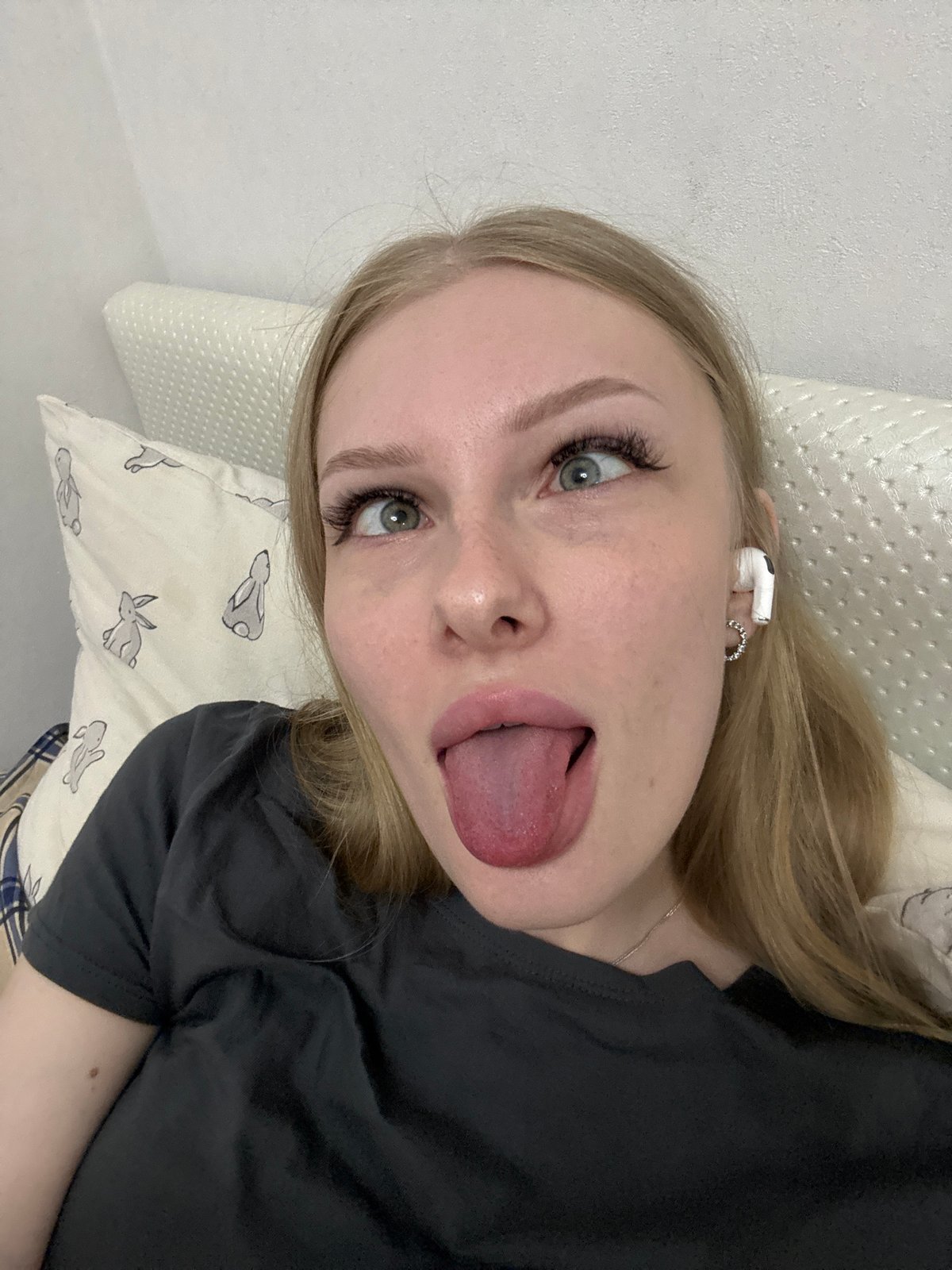 Relaxing at home in Perm, earbuds in, taking it easy