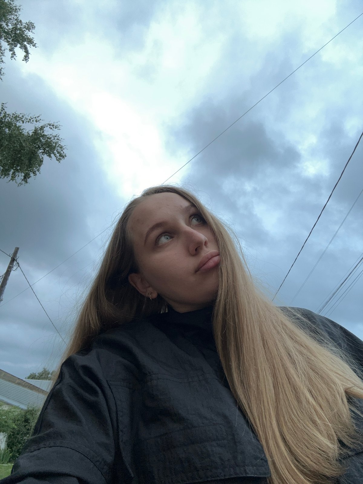 Woman photographs herself outdoors in Chaikovsky, Russia