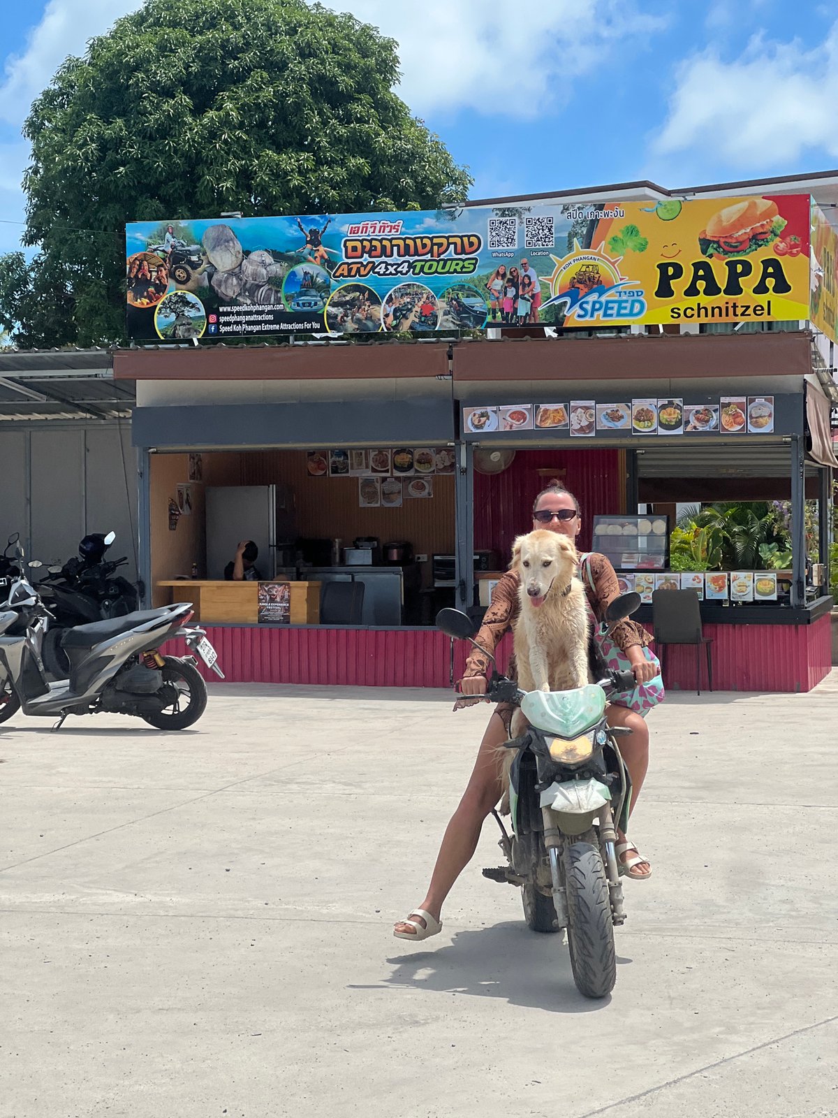 Everyday street traffic moves through Koh Phangan, Thailand