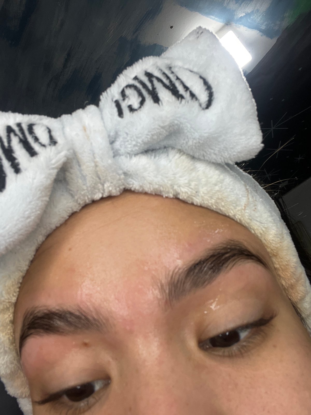 DIY eyebrow waxing at home, dogs lounging close by