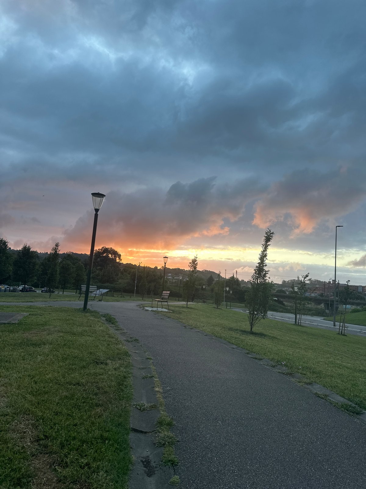 Dramatic sunset photographed over Gijón park during golden hour