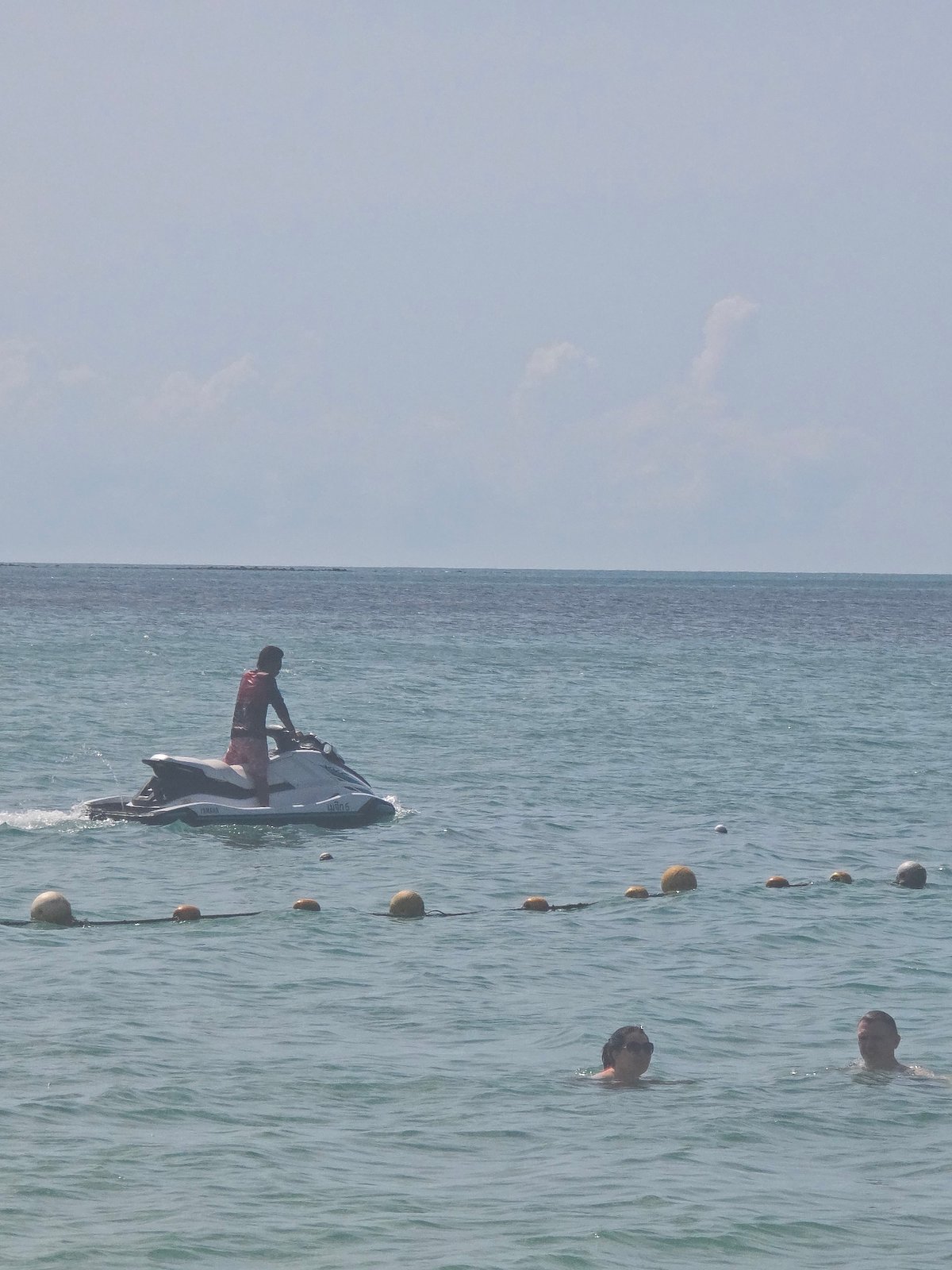 Lamai Beach in full swing: water toys, jet skis, and beachgoers