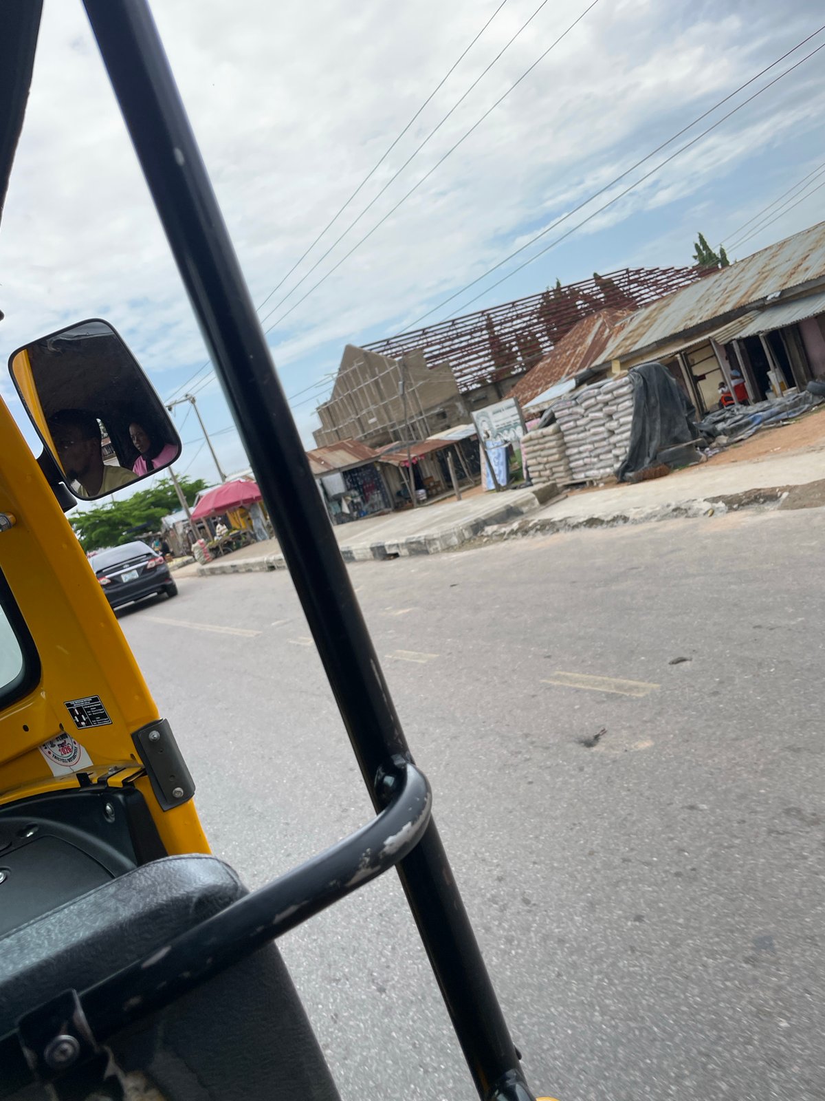 Street life and roadside commerce across a busy Jalingo morning