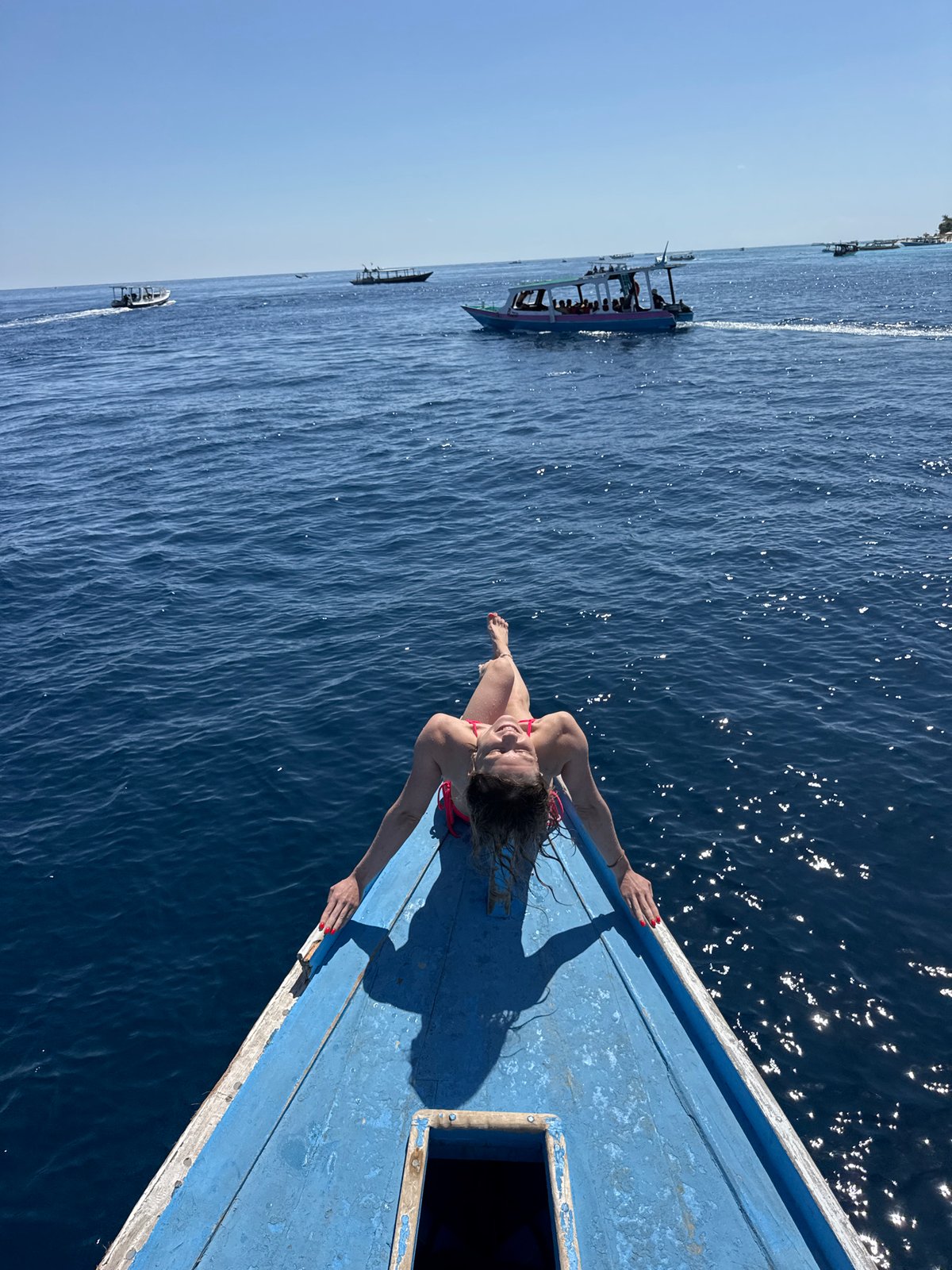 Boat bow hangout on open blue water, Indonesia