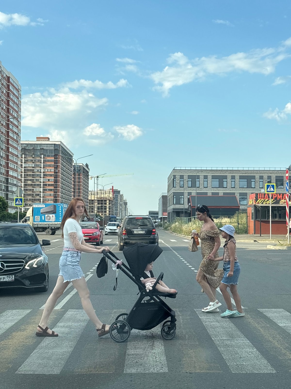 Street-level glimpse of a Krasnodar neighborhood on a clear summer day