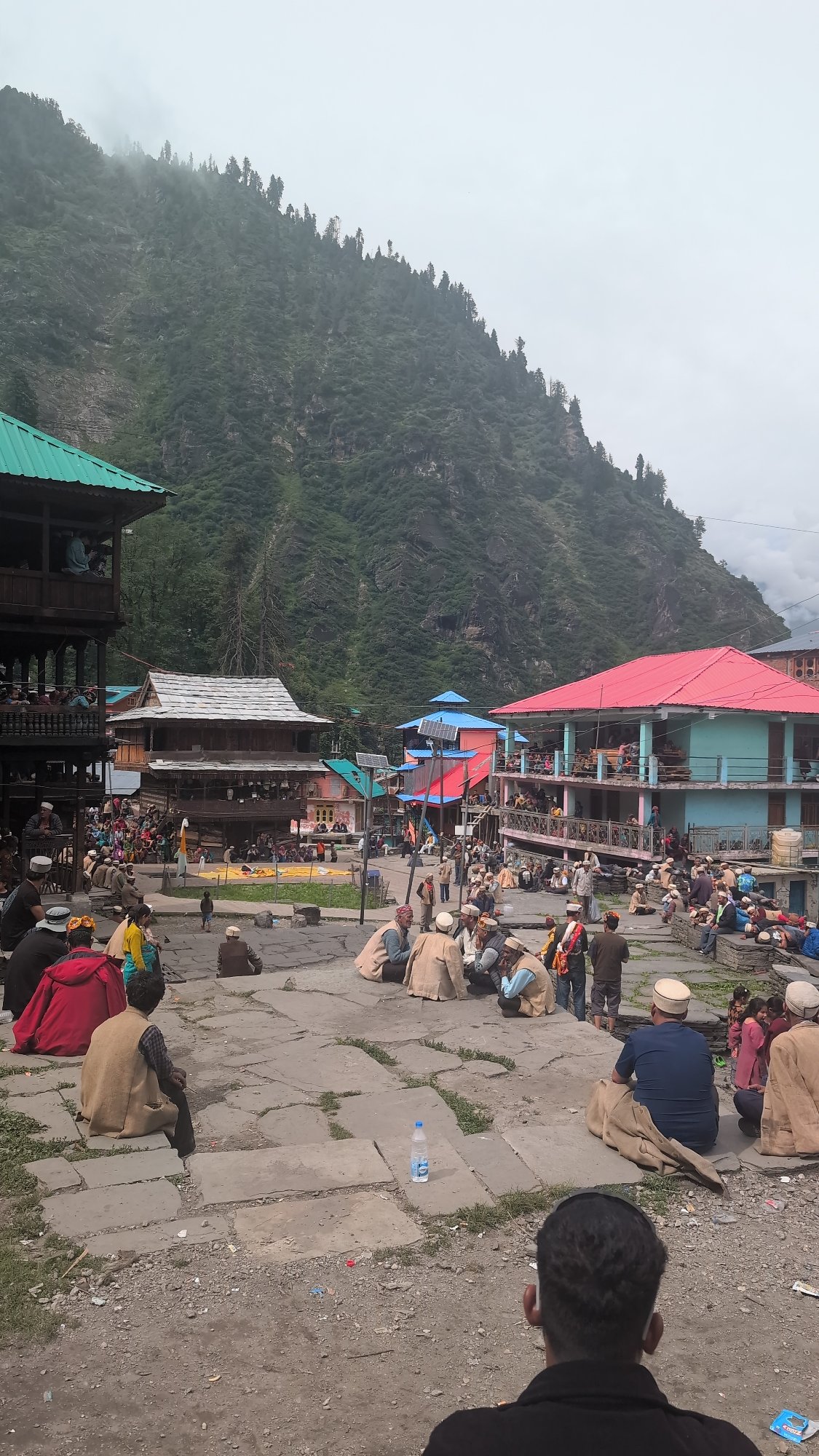 Community gathering in Malana's traditional mountain village