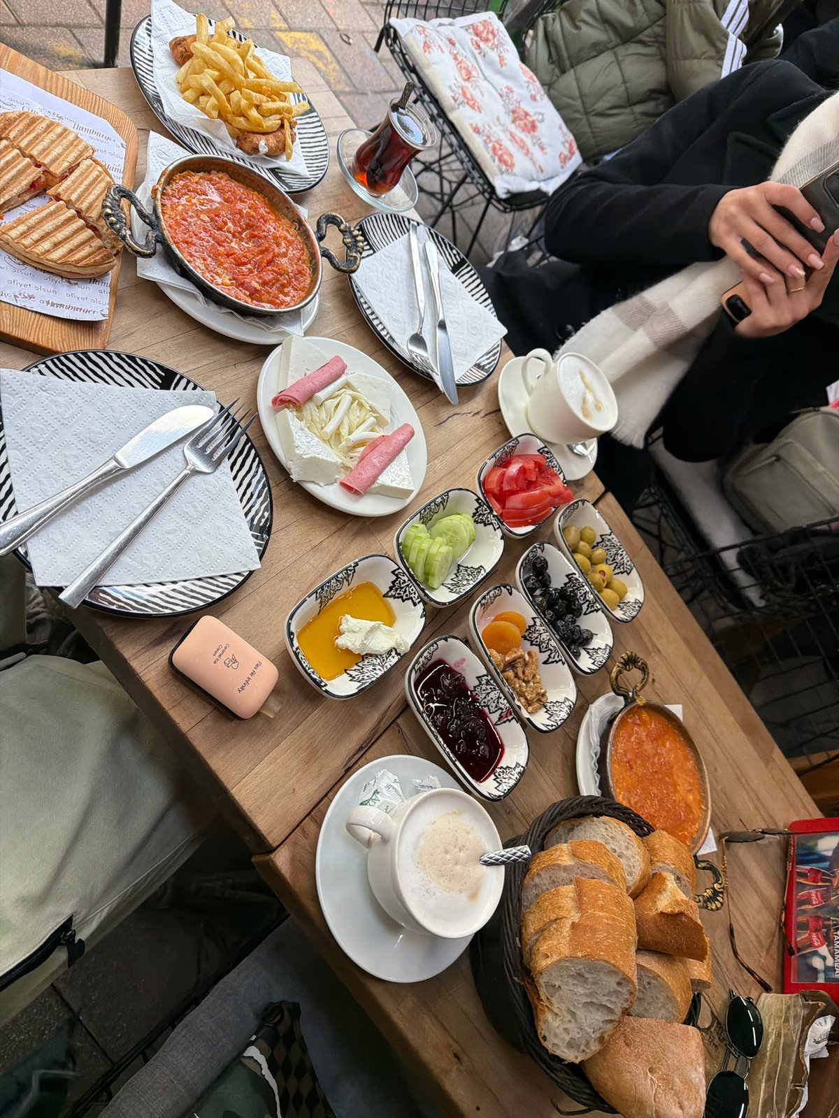 Couple enjoys traditional Turkish breakfast at Istanbul outdoor cafe