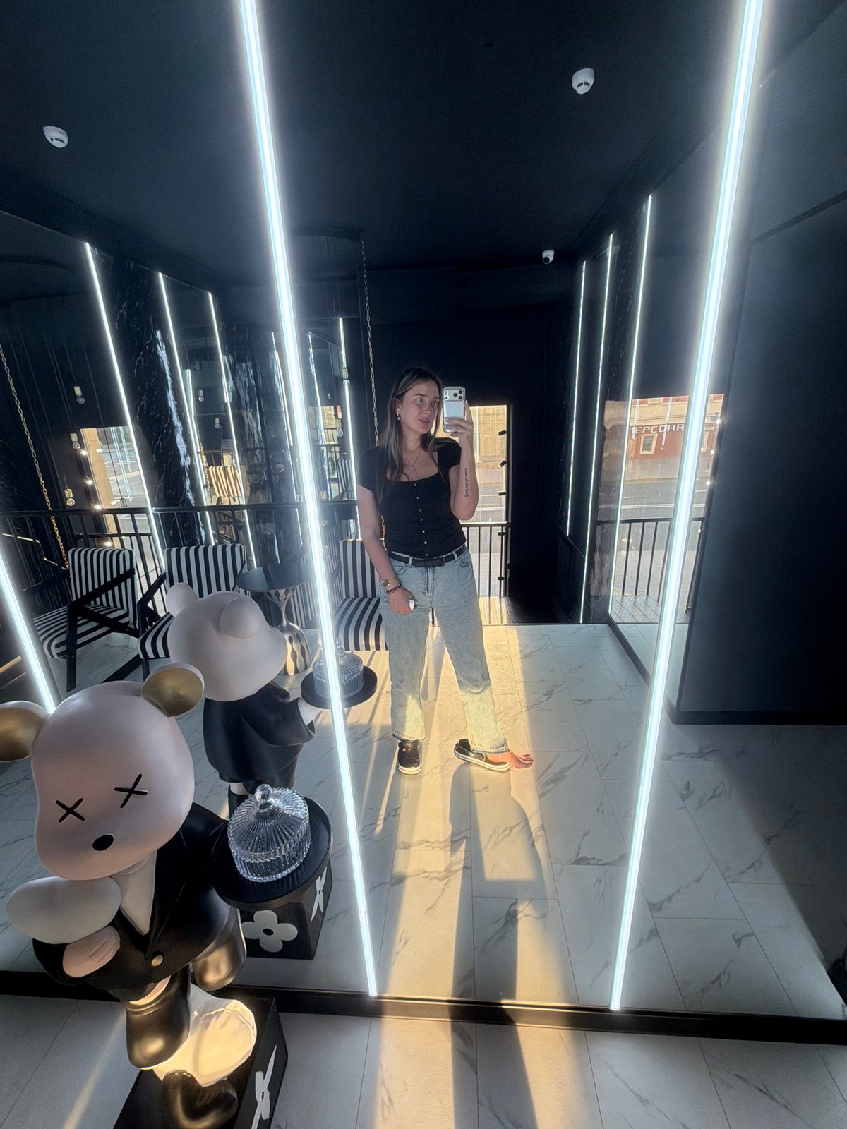 Woman takes mirror selfies in modern Ukrainian interior