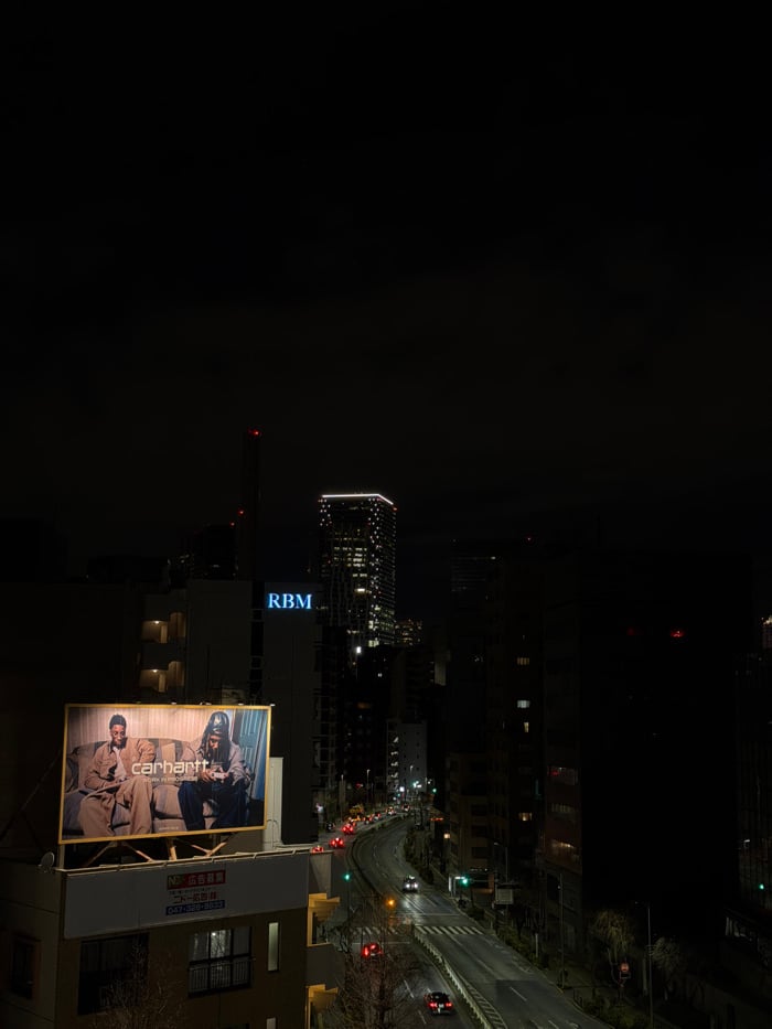 Aerial nighttime view captured over Shibuya streets from elevation