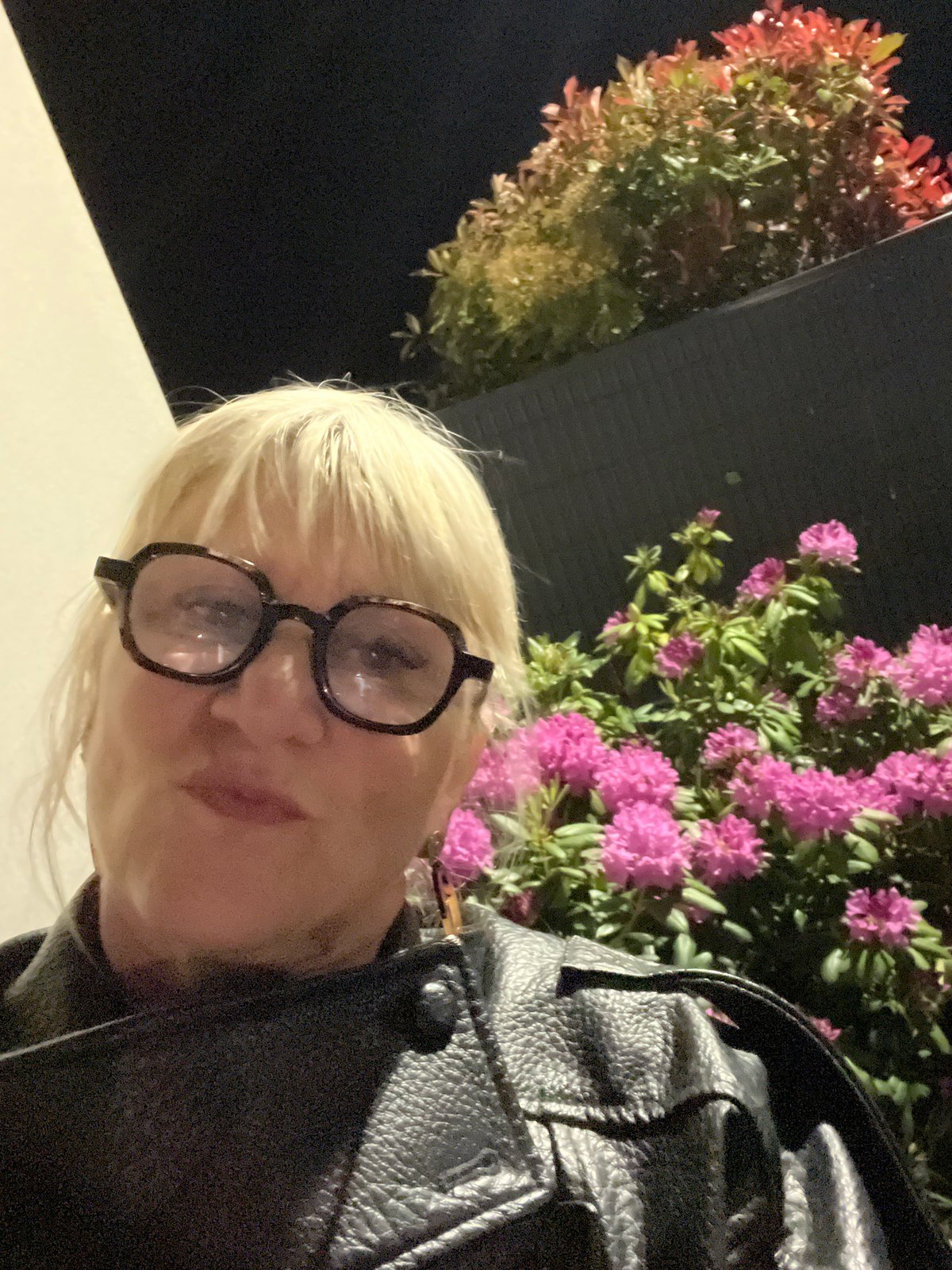 Portrait captured amid pink flowers in Chambœuf, France