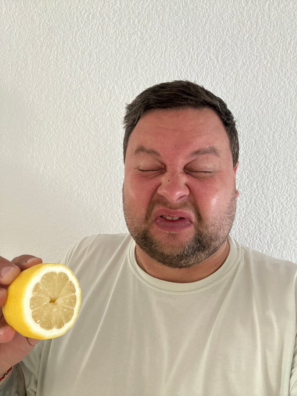 Man tastes lemon in Spanish coastal town fruit display