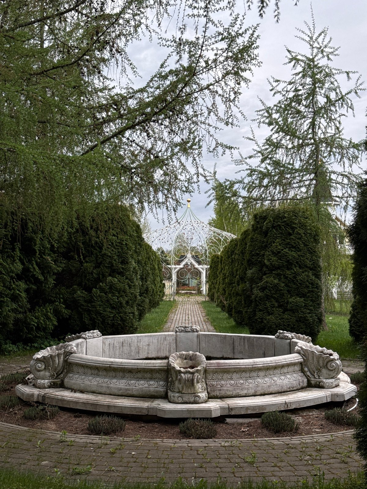 Park scene documented in Sapronovo featuring fountain and gazebo