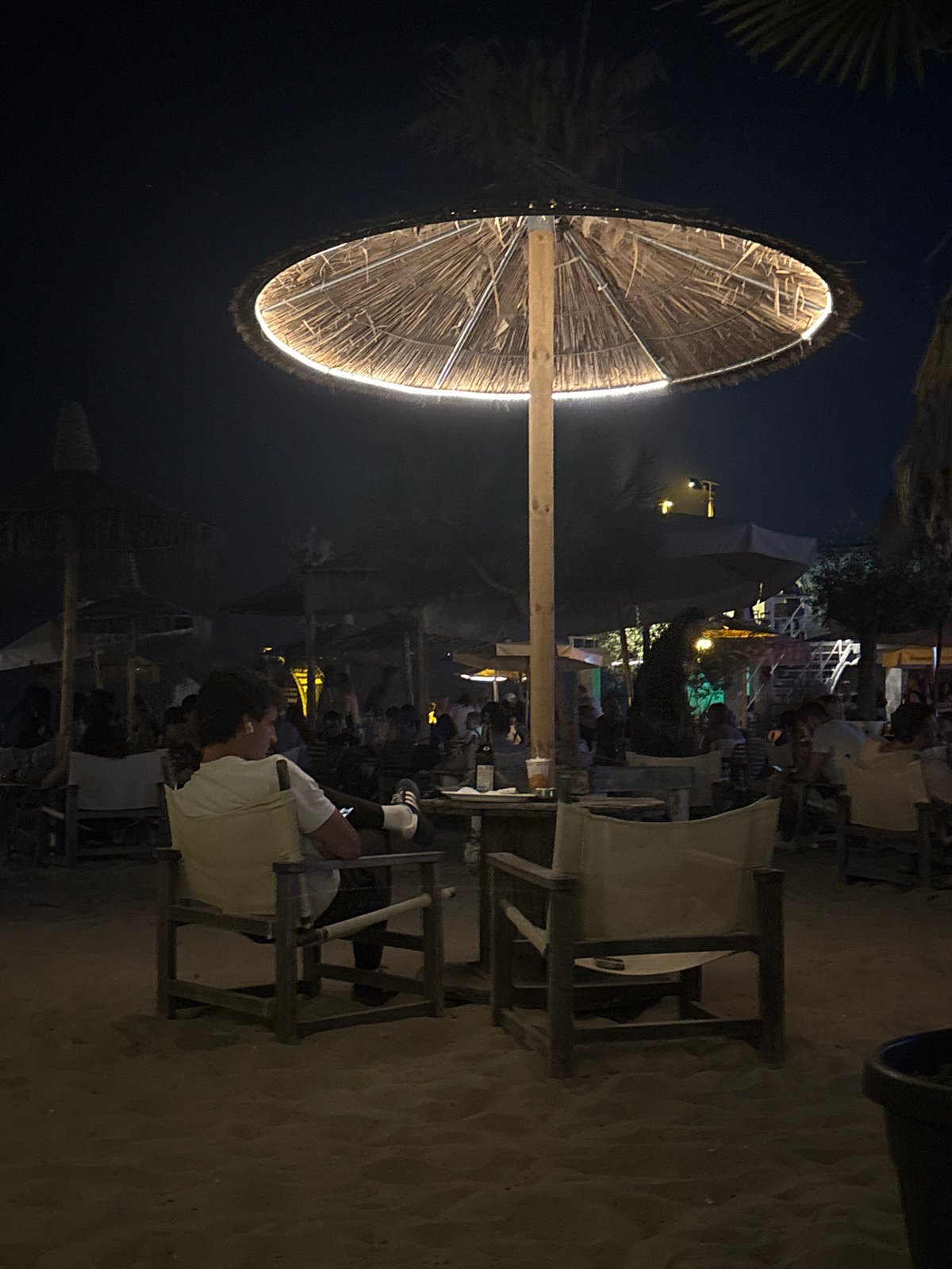 Night out at a lit-up beachside bar with quirky murals