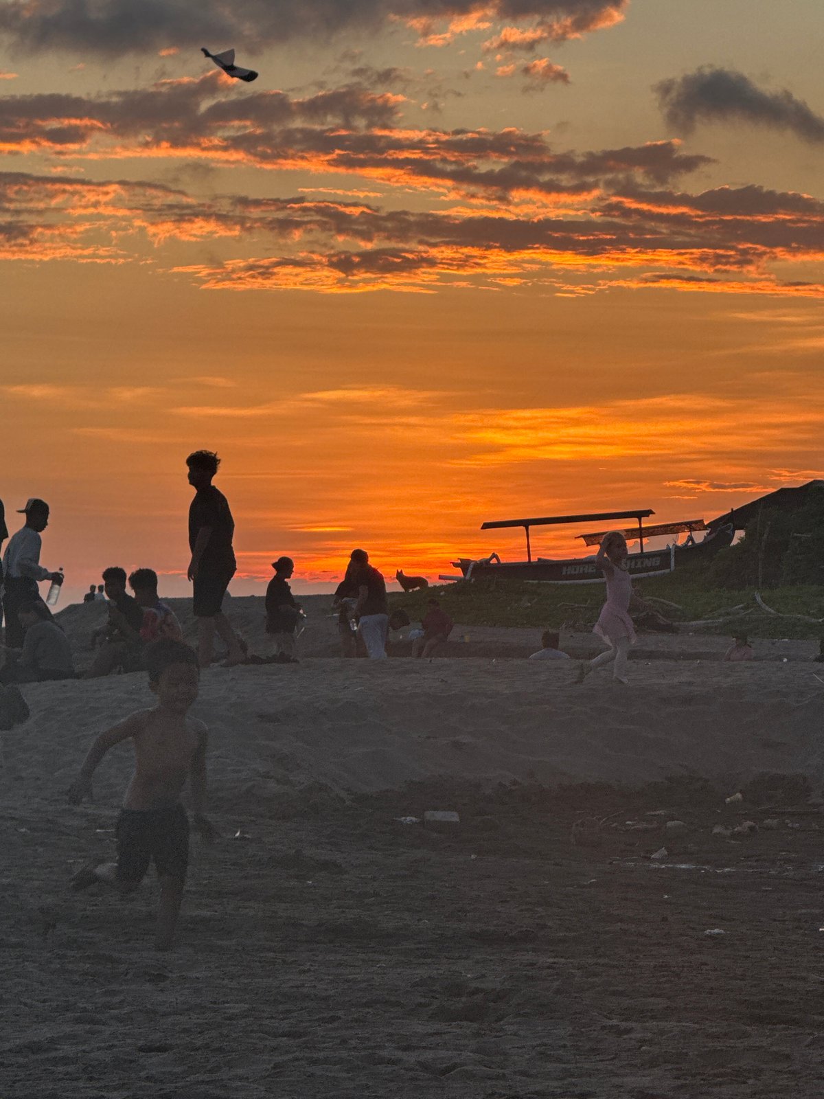 Kite flying and beach activities observed in North Kuta