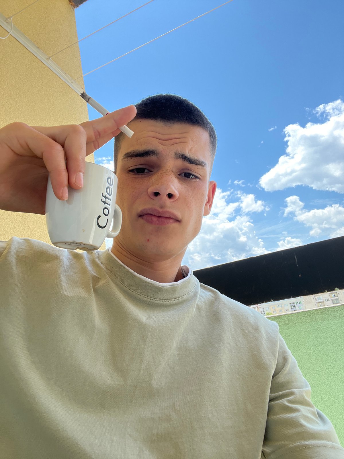 Coffee and cigarettes on a Sopot balcony, city views behind