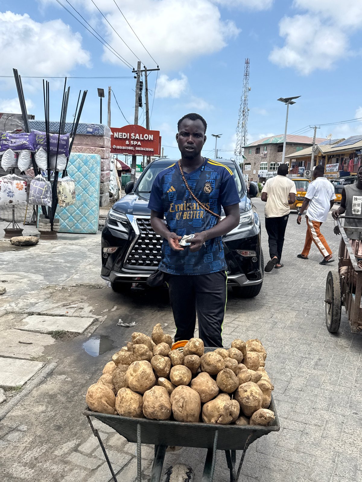 Daily street commerce and repairs observed in Ado, Nigeria