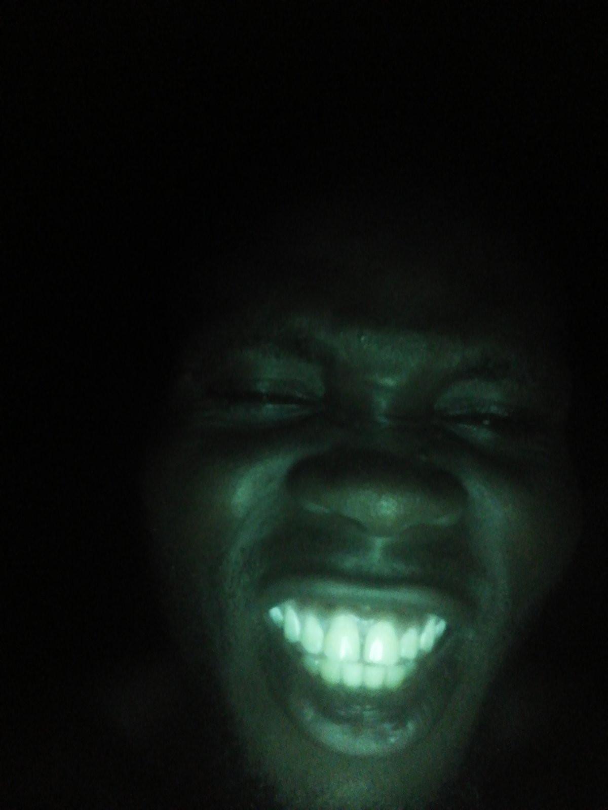 Person photographed in low-light conditions, unknown location