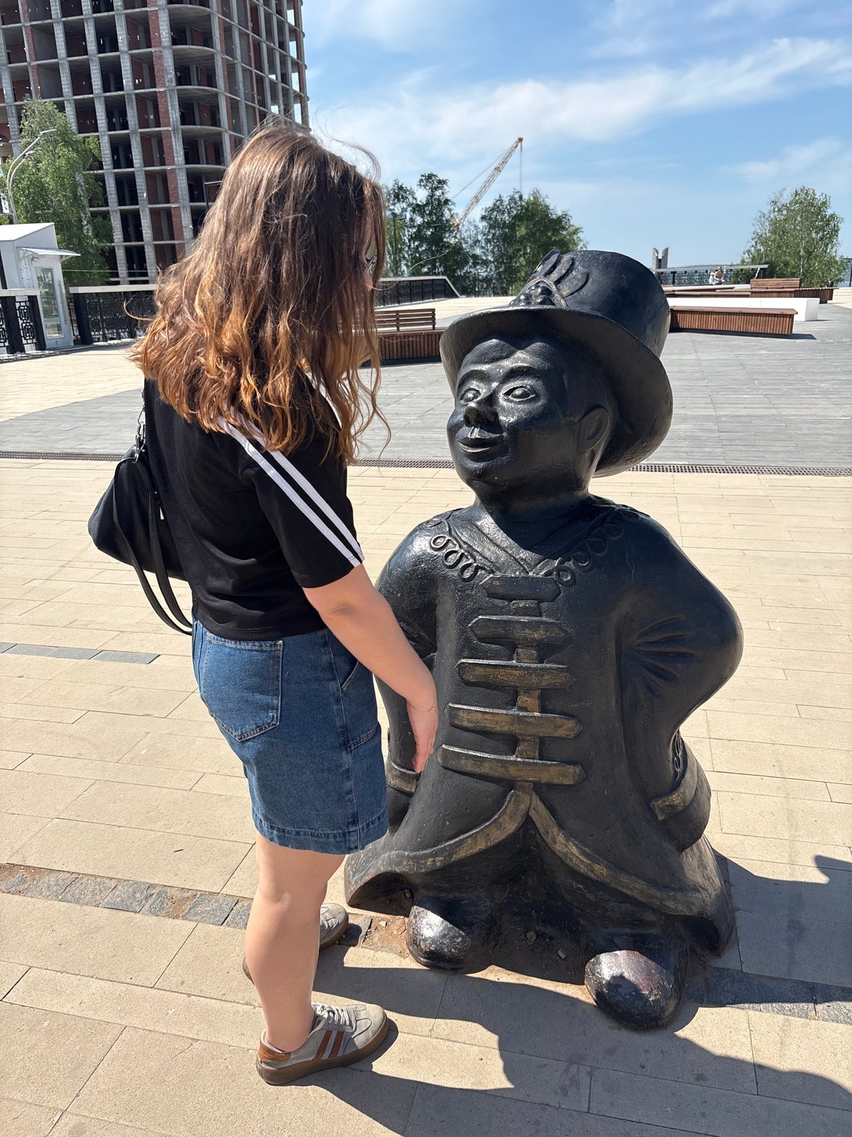 Woman photographed near statue in Izhevsk public square