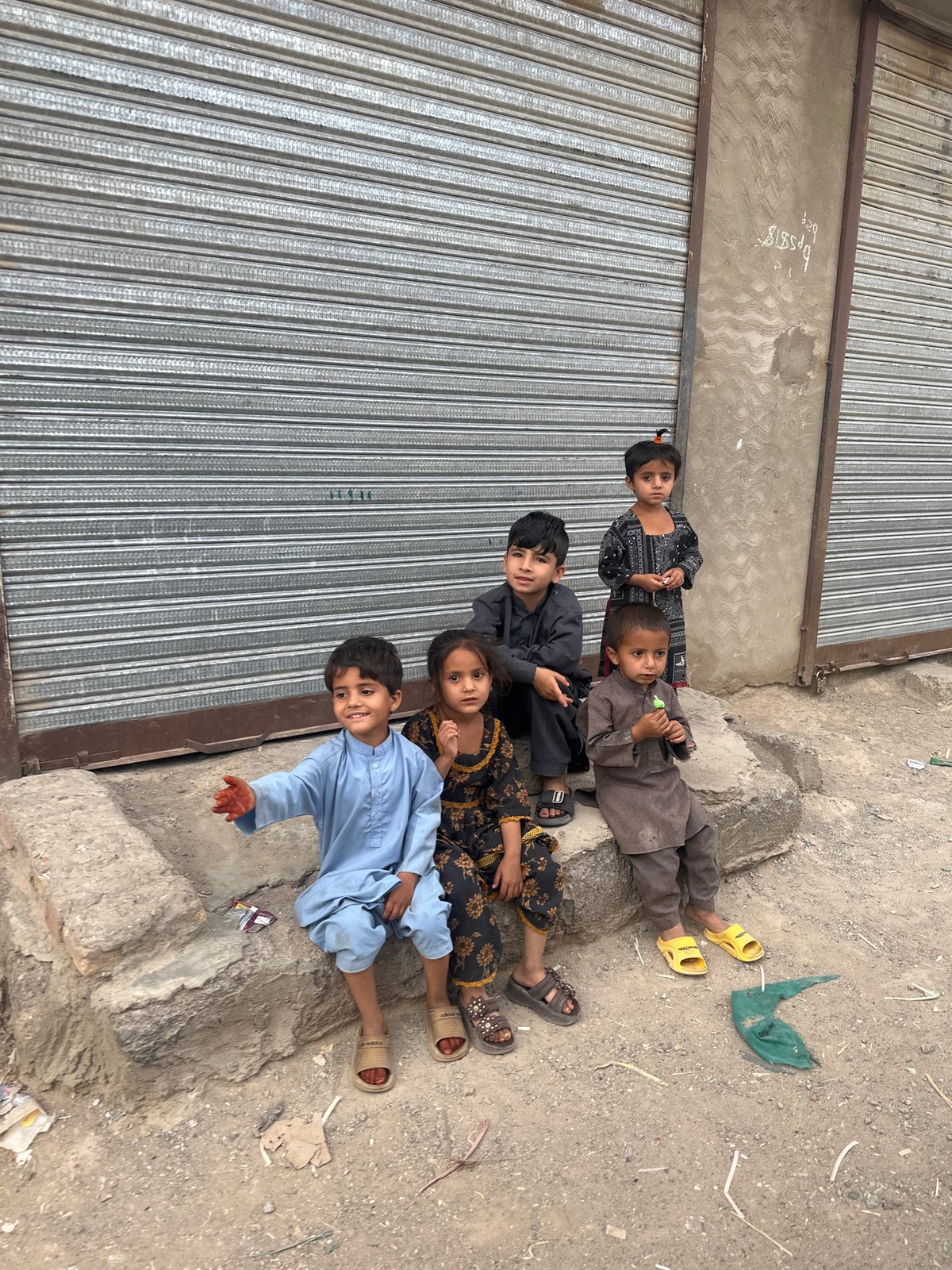 Five children lie near closed storefront in Quetta