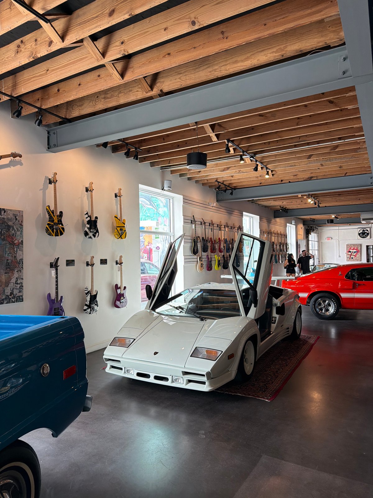 Miami showroom blends supercars, rock guitars, and football shirts
