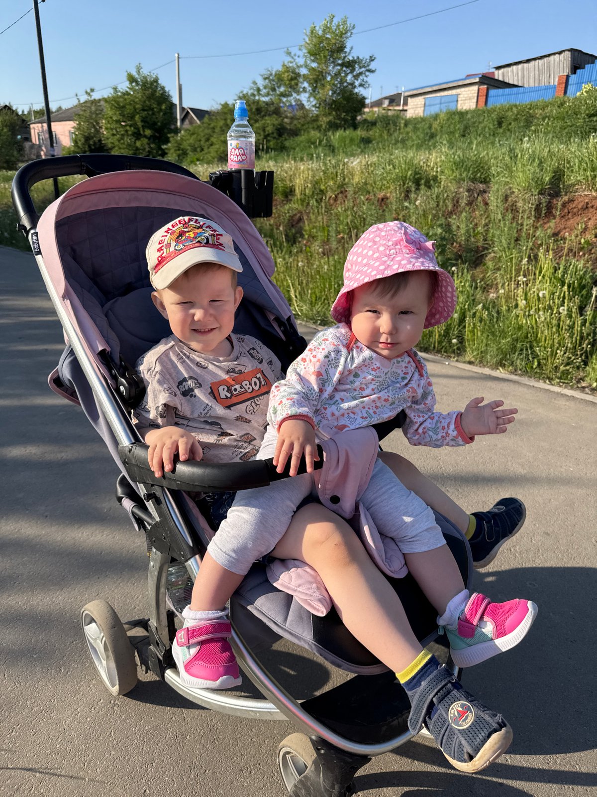 Two children share stroller ride in Zav'yalovo, Russia