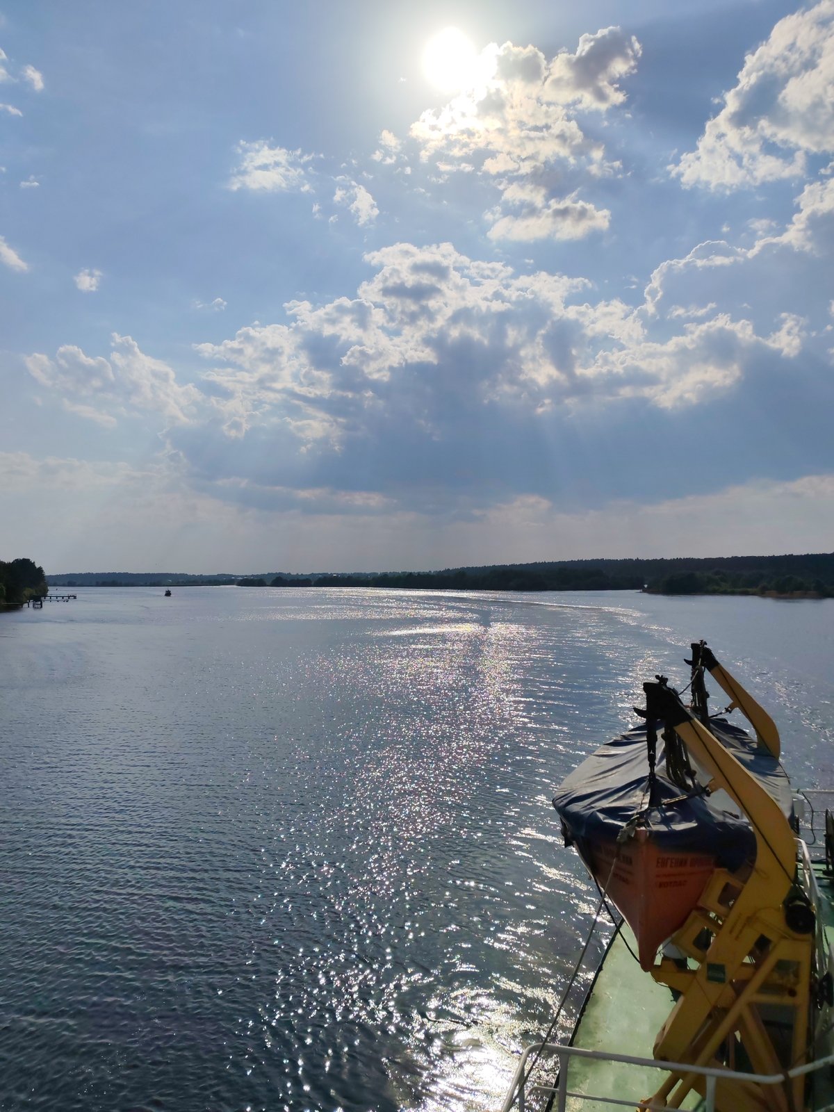 Boat travels Volga River near Kimry under sunny skies