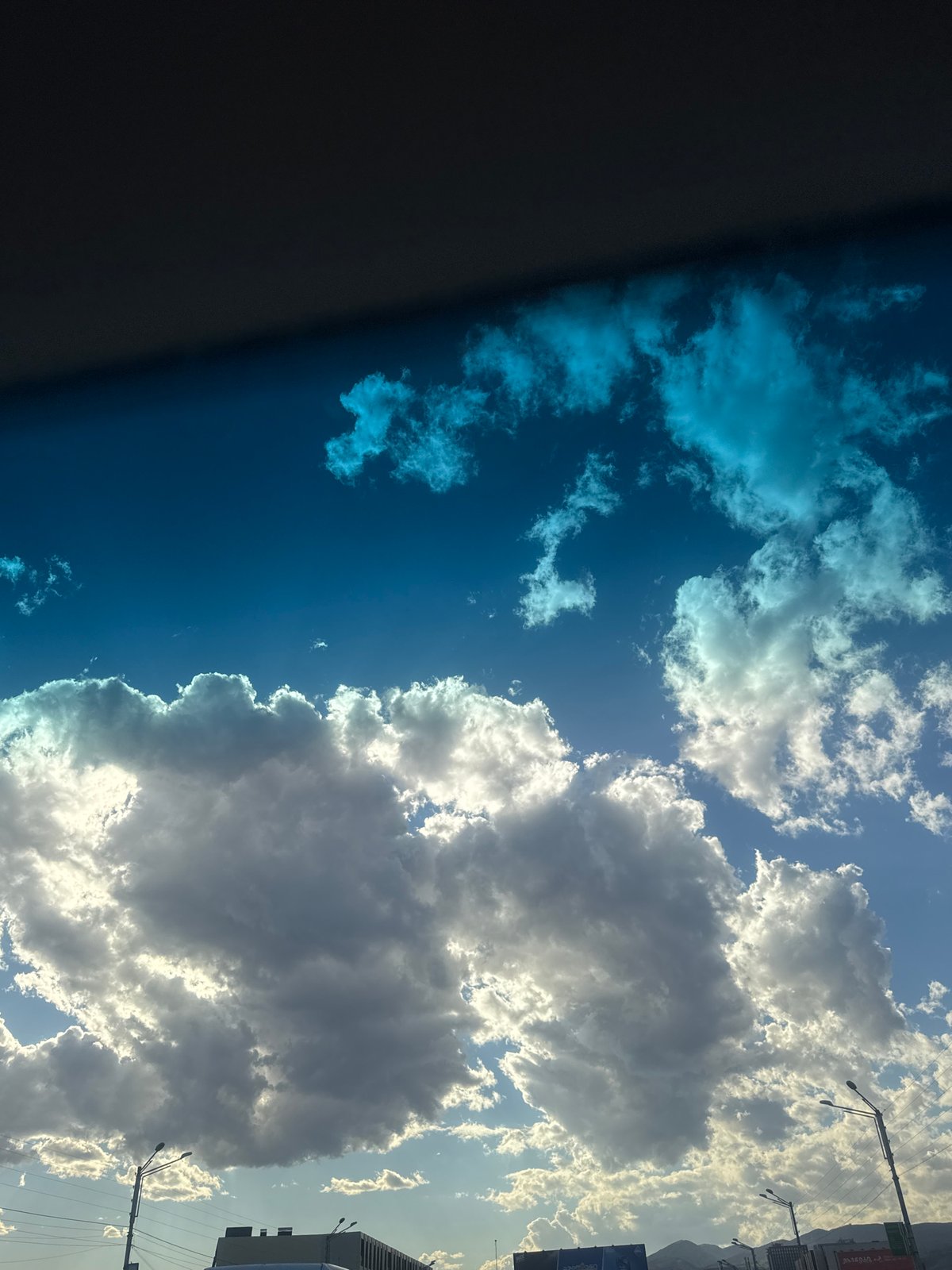Woman documents car journey through Tbilisi on sunny afternoon