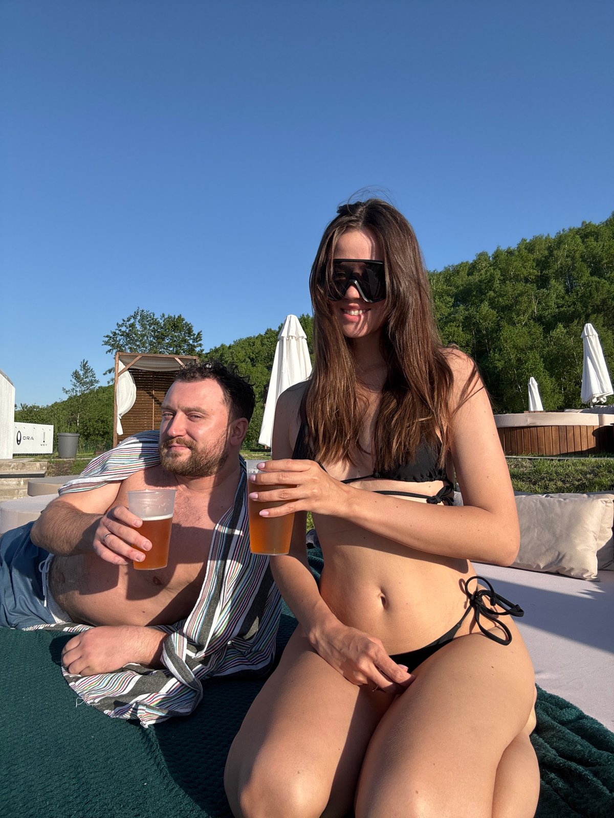 Couple enjoys sunny poolside afternoon in Дрокино, Russia