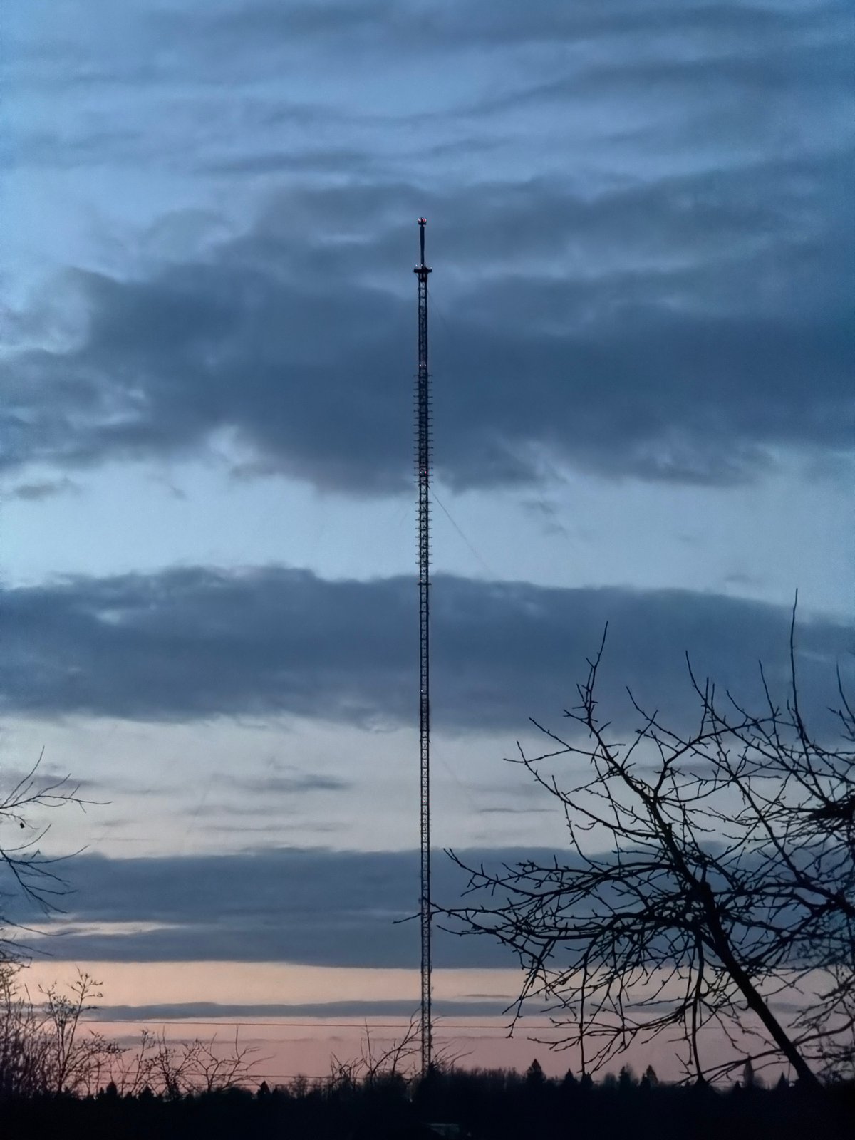 Radio tower observed under cloudy skies in rural Russia