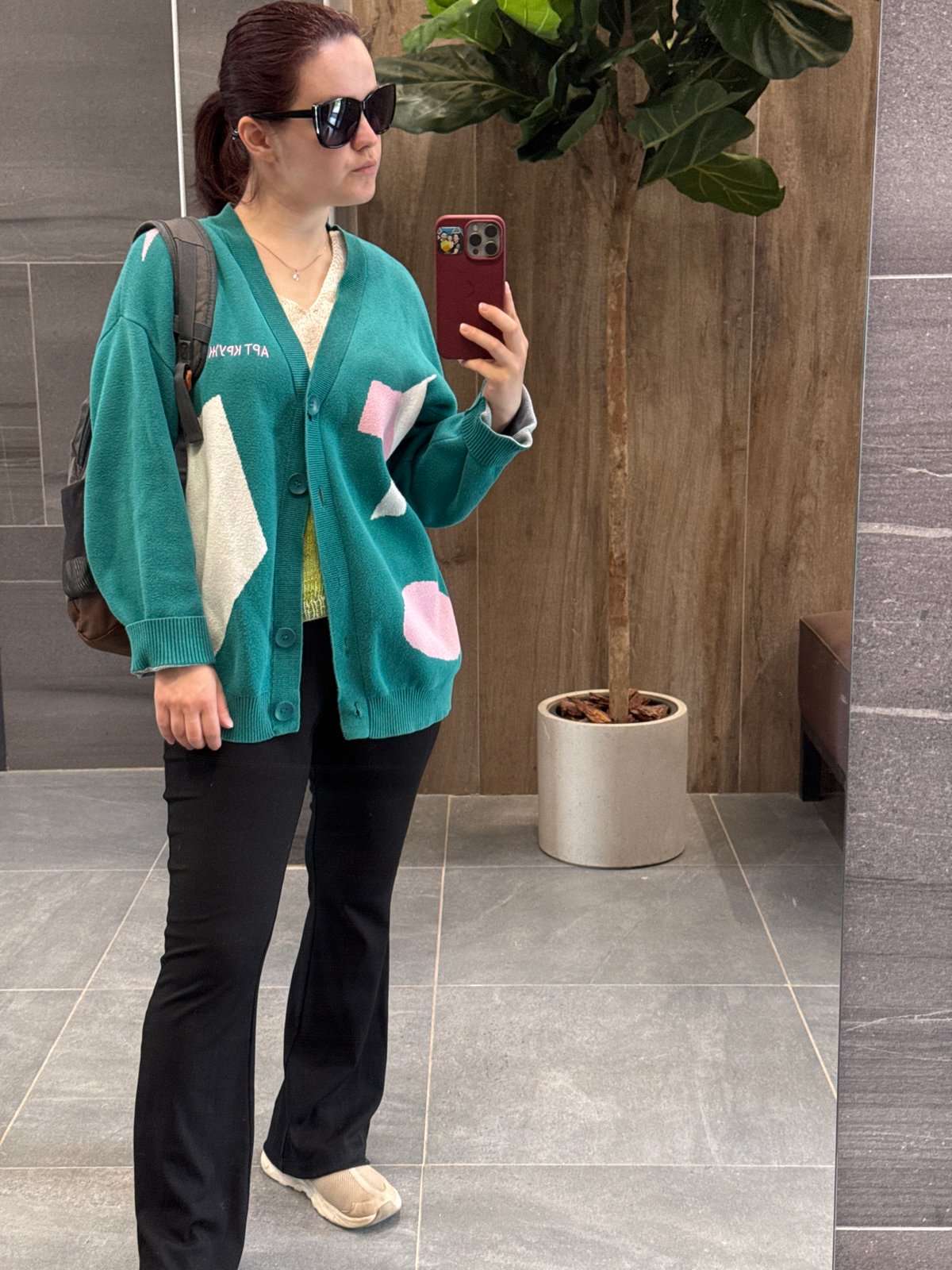 Woman takes mirror selfie in Izhevsk building lobby