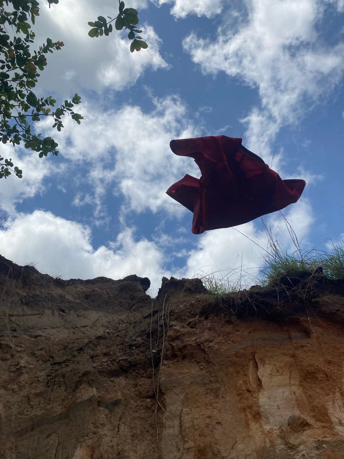 Red cloth caught suspended mid-air near cliff in Amaseri