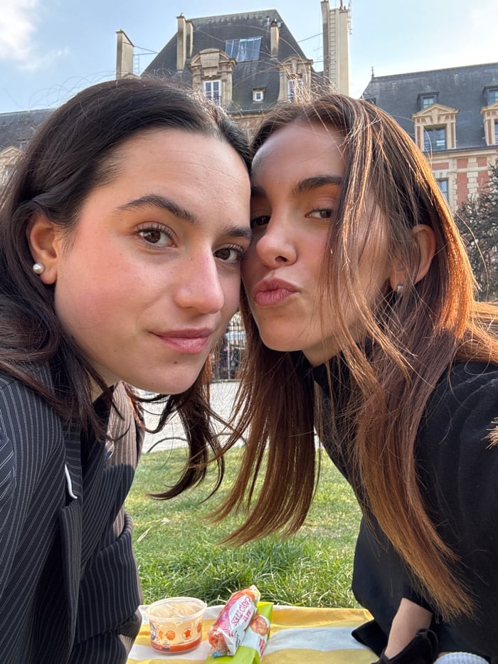 Friends enjoy sunny afternoon picnic at Paris's Place des Vosges