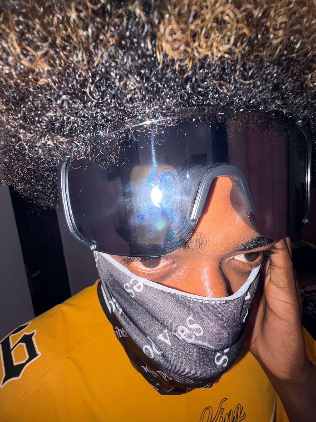 Person in goggles and patterned head covering photographed