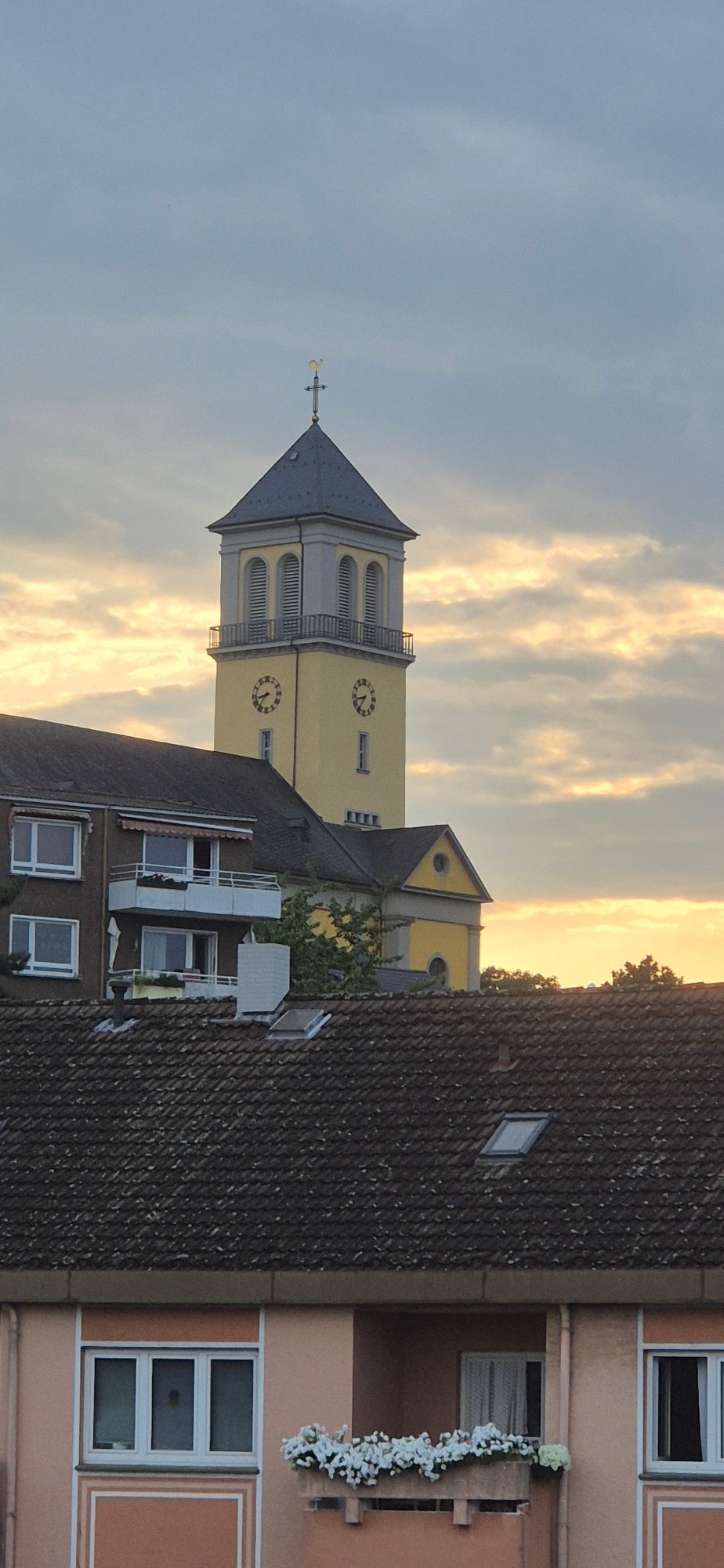 Yellow church tower with twin clock faces, Mainz