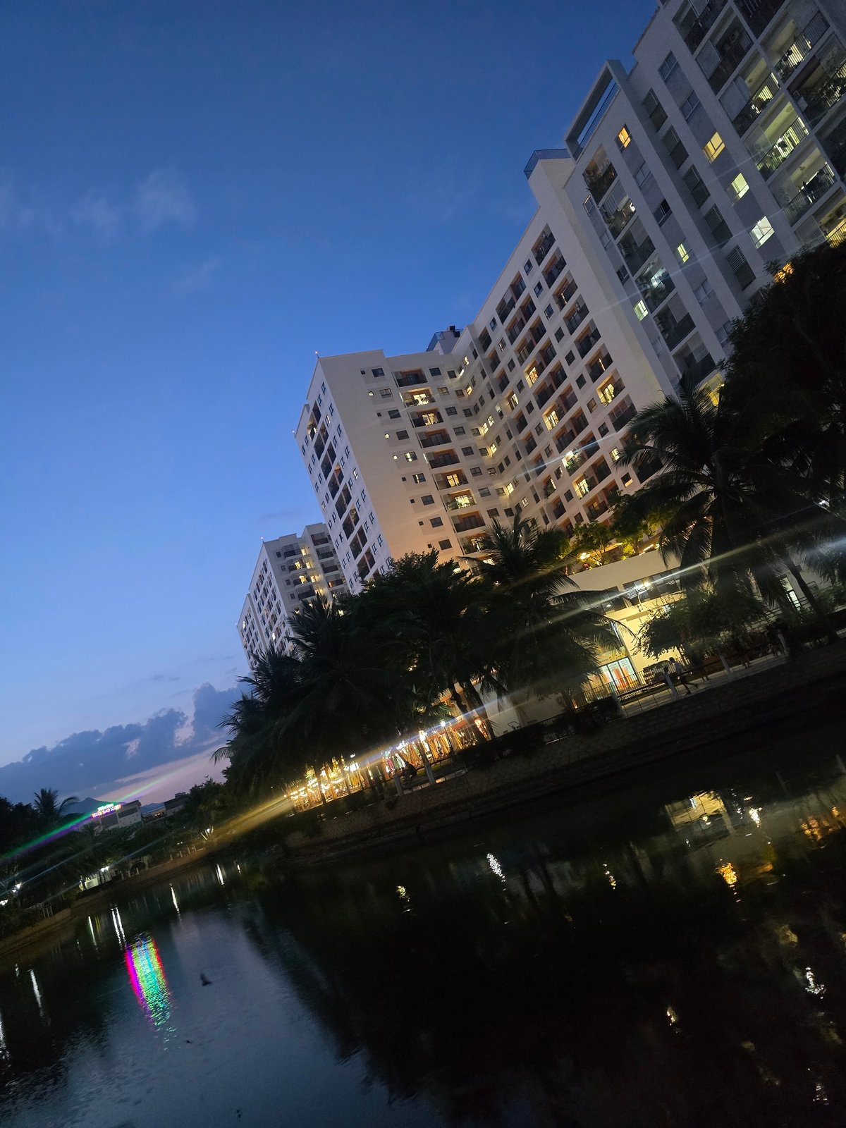 Nha Trang at night: apartment towers and lantern-lit garden seating