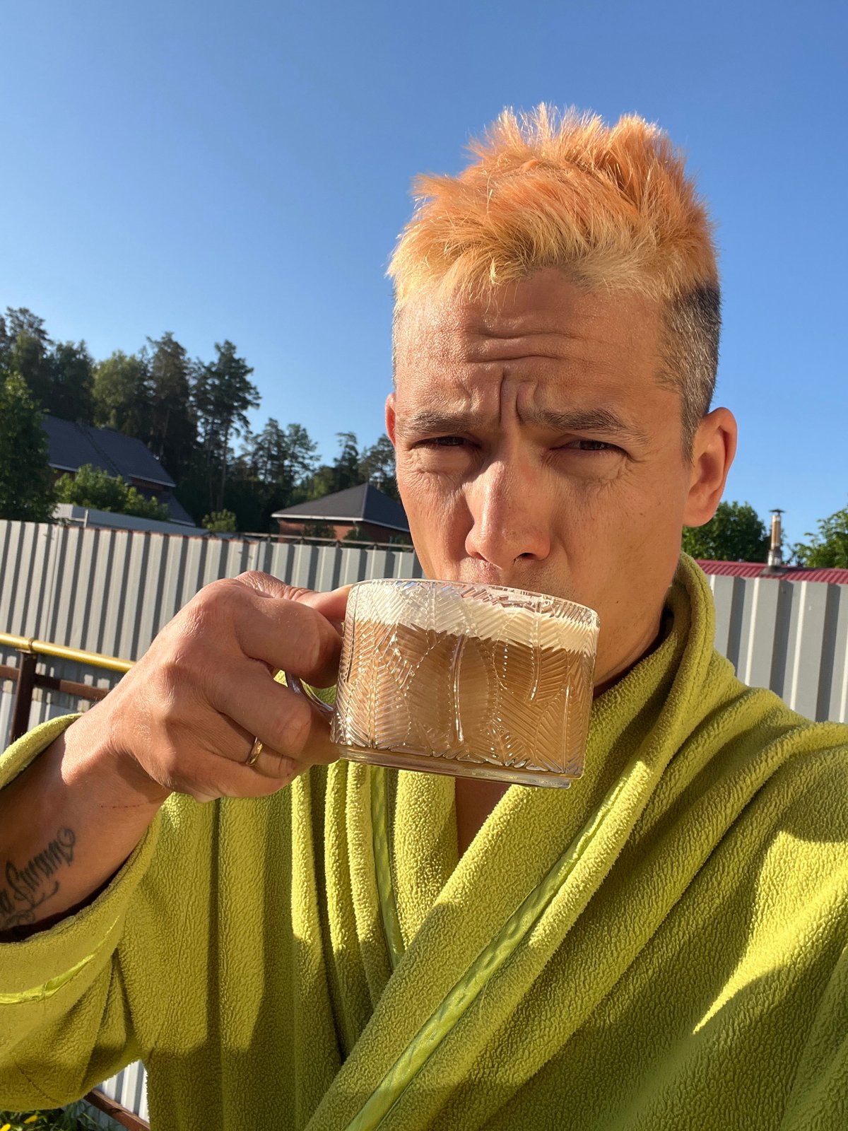 Man enjoys morning beverage outdoors in Chaikovsky, Russia